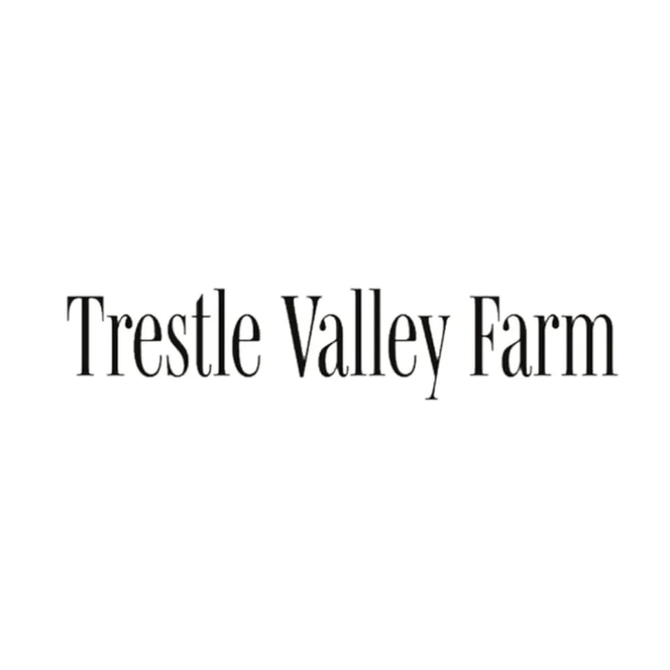 The words "Trestle Valley Farm" in black serif font on a white background.